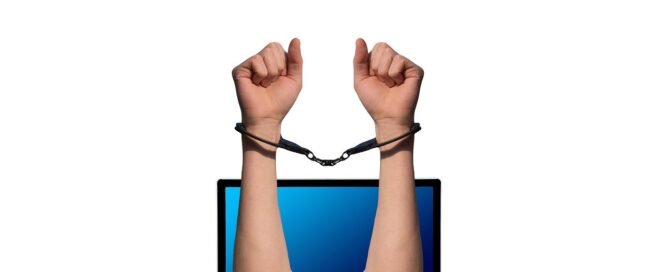 Laptop screen showing cybersecurity protection and digital shield representing cyber liability insurance for freelancers