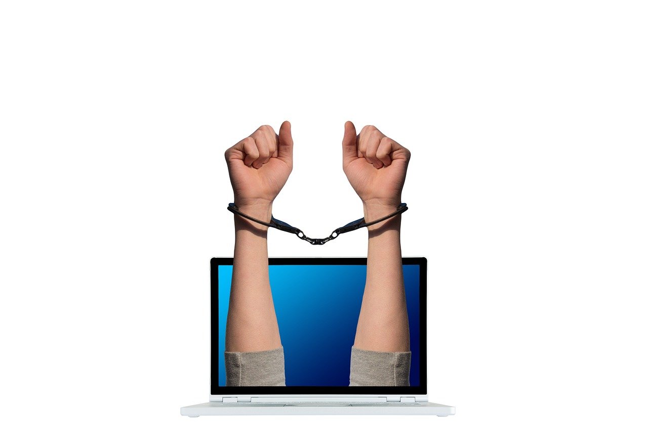 Laptop screen showing cybersecurity protection and digital shield representing cyber liability insurance for freelancers