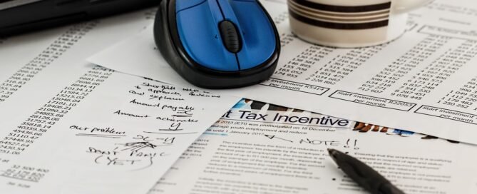 Business documents and tax forms on a desk representing S-Corp vs LLC decision for freelancers