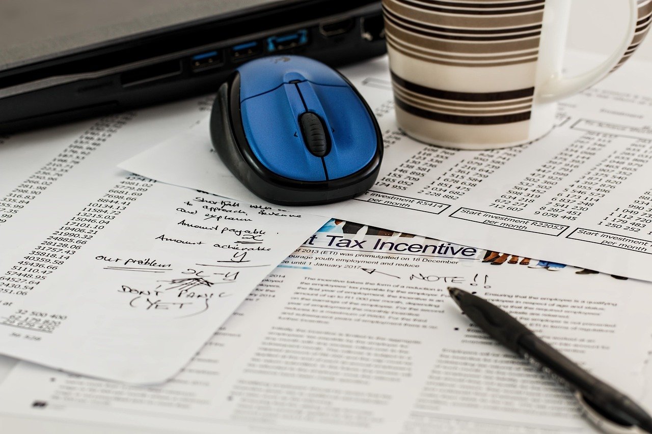 Business documents and tax forms on a desk representing S-Corp vs LLC decision for freelancers